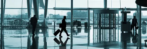 Photo of man walking through airport
